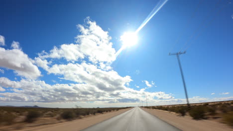 driving west into the sunshine and cloudscape over the mojave desert - point of view hyper lapse