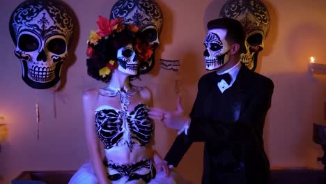 couple dressed in day of the dead costumes