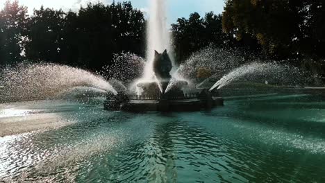 Still-shot-of-a-majestic-fountain-in-the-middle-of-the-park-in-slow-motion,-isolated-fountain-and-water-jets