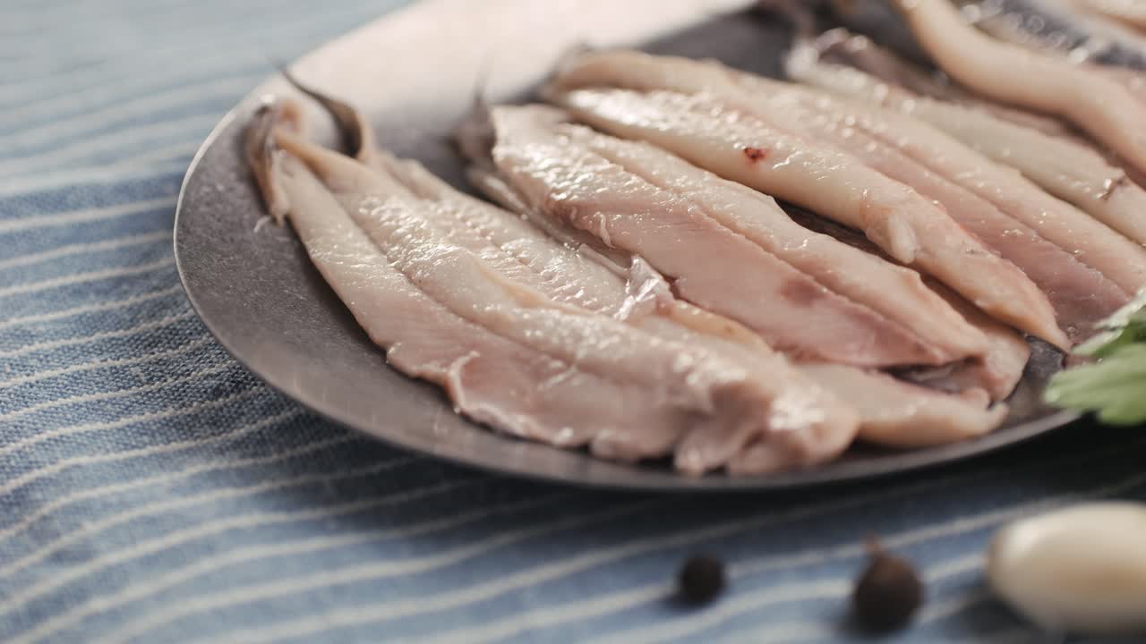 Fresh Sea sardines and Anchovy Fish and Mullus On Display On Ice On Market Store Shop. Seafood Fish Background, close up stand of small salty white fish.