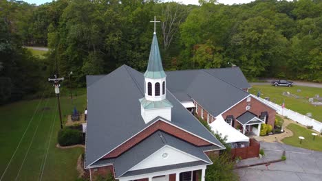 a close up drone shot of an old church steeple in rural south carolina