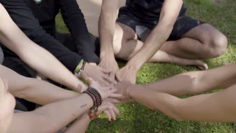 cropped shot of yoga people stacking hands outdoor