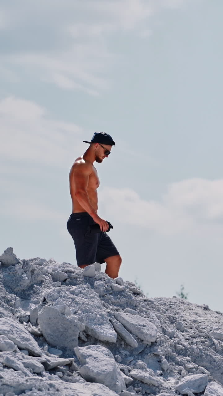 Aerial view of a muscular sexy man. Bodybuilding and outdoor sports concept Vertical video