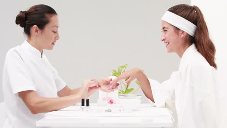 woman getting a manicure at nail salon