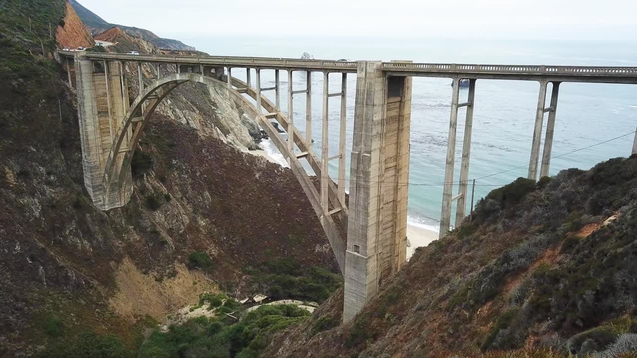 los coches conducen en el puente del cañón bixby cerca de la costa de big sur en california