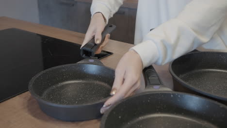 woman preparing food in kitchen with new pans