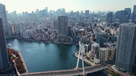 aerial drone reveal shot flying over river in tokyo city japan