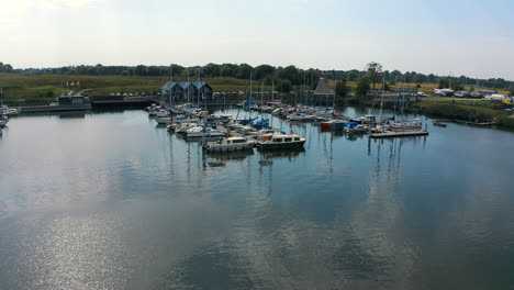 Aerial-shot-of-drone-flying-around-marina-in-Blotnik,-Pomeranian,-Poland-with-boats-in-the-background