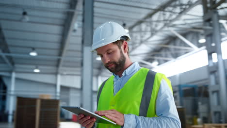 portrait factory employee tablet checking analysing production supply smiling