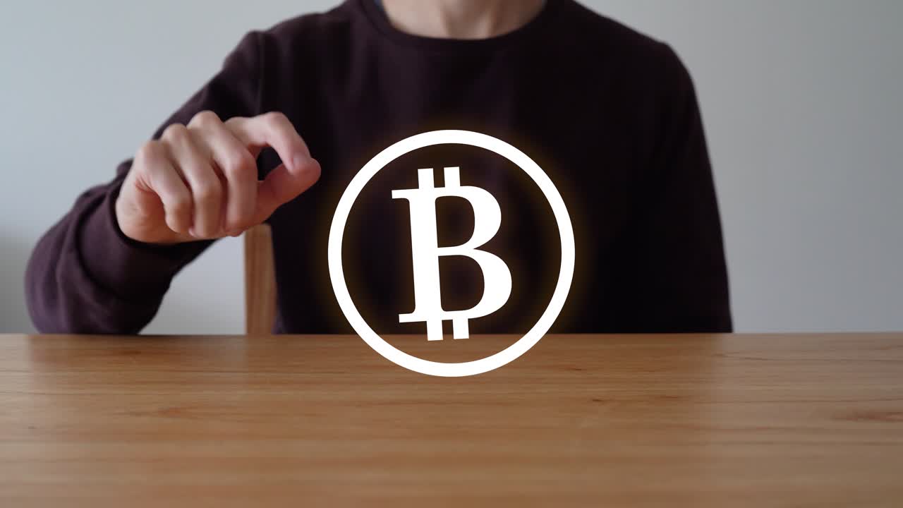 Man Touch The Bitcoin Icon Floating In Wooden Table. - closeup shot