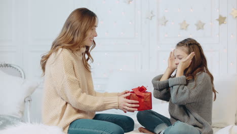 cheerful girl getting new year present on bedroom