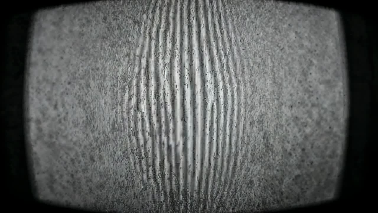 Showing CRT-style monitor emitting static then revealing central dark band while noise flickering