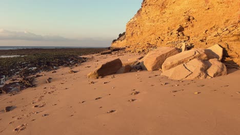 Strolling-amidst-rugged-stone-and-rocky-formations-that-embellish-the-seascape-backdrop