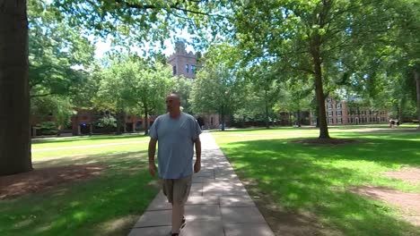 man walking on campus tilt up 4k