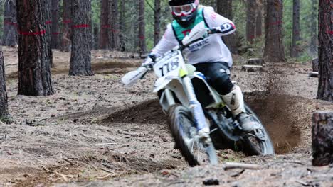 young female on dirtbike in the forest at high speed slow motion, motocross 60fps