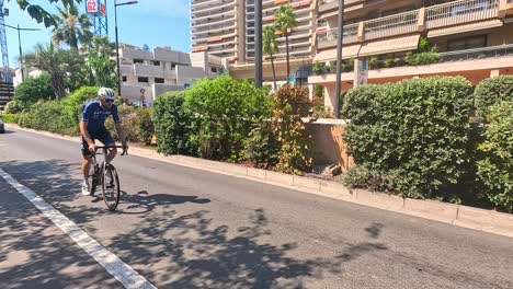 cyclists ride through urban monte carlo scenery