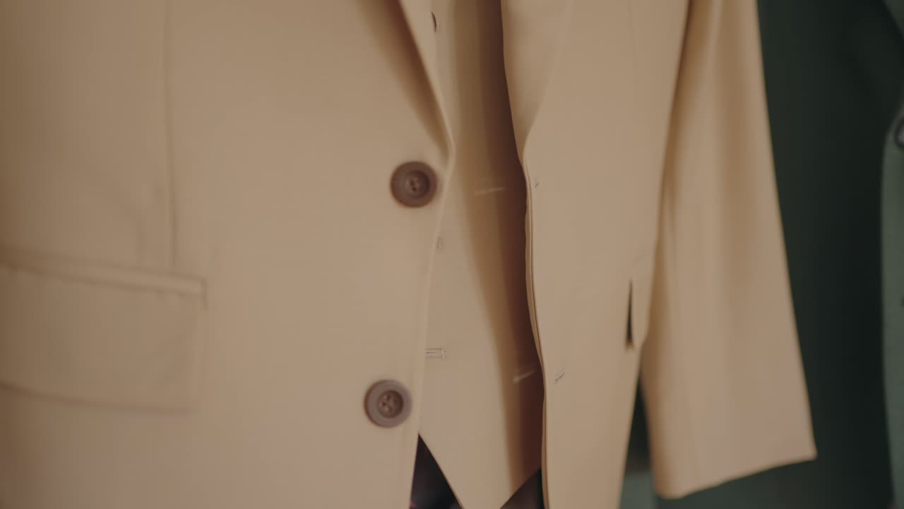 Beige suit jacket with buttons and tailored fabric details
