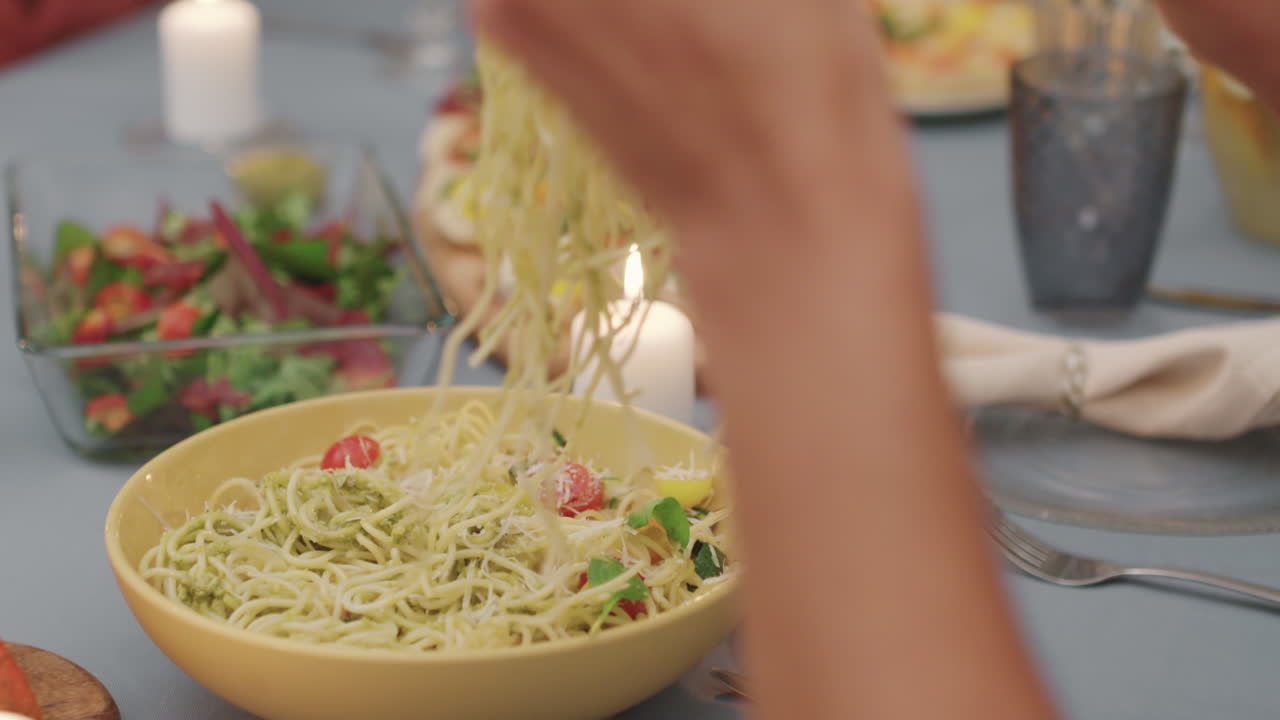 Putting Pasta On Plate During Dinner