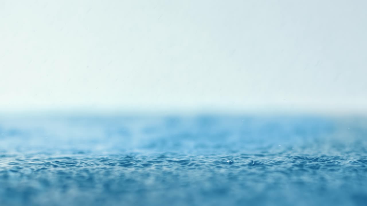 Premium stock video - Rain water drops falling in super slow motion.