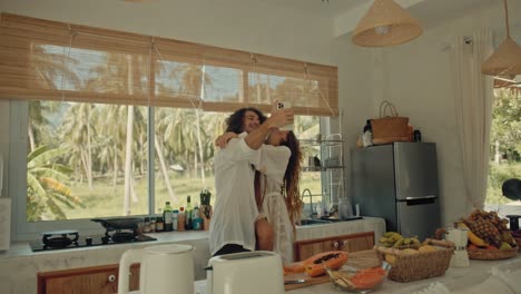 couple taking selfie in tropical kitchen