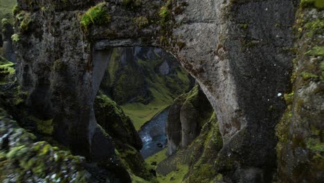 fjadrargljufur canyon - dramatic flight under natural bridge into a ravine