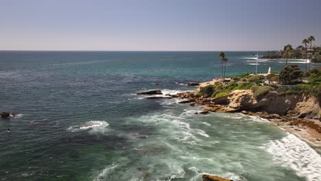 Laguna-Beach-California-drone-view-of-the-beach-and-birds-flying-into-the-frame