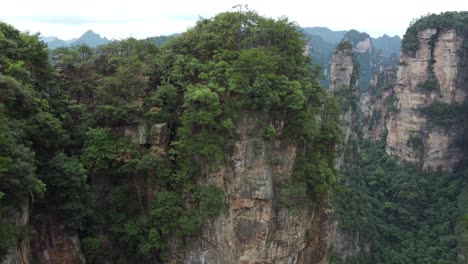 drone descending beneath "avatar hallelujah mountain" in the tianzi mountain range of hunan province, china