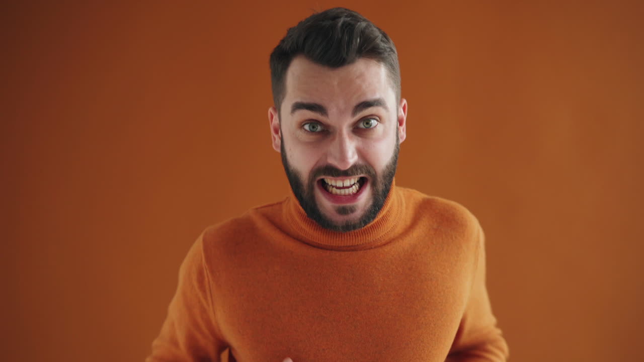 Surprised Man in Orange Sweater
