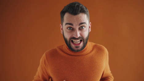 surprised man in orange sweater