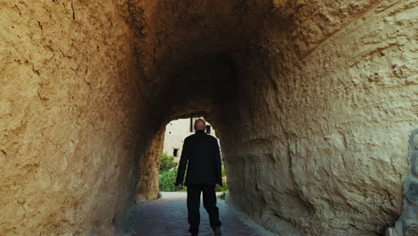 tourist walking and explores an ancient tunnel inside a medieval castle