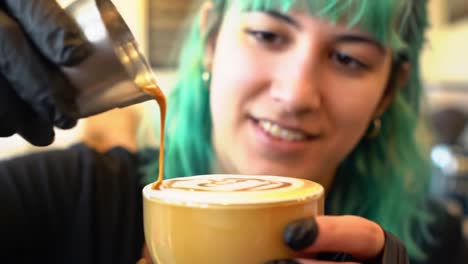 a barista with vibrant green hair skillfully creates latte art, pouring a beautiful design into a cup of coffee with expert precision and careful attention