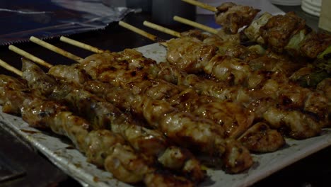 closeup of freshly grilled barbecue on sticks along the street.