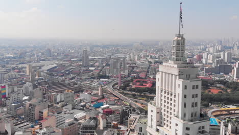 aerial view of altino arantes building, called banespao with the flag fluttering, sao paulo downtown, brazil