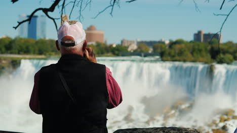 elderly man takes pictures niagara falls