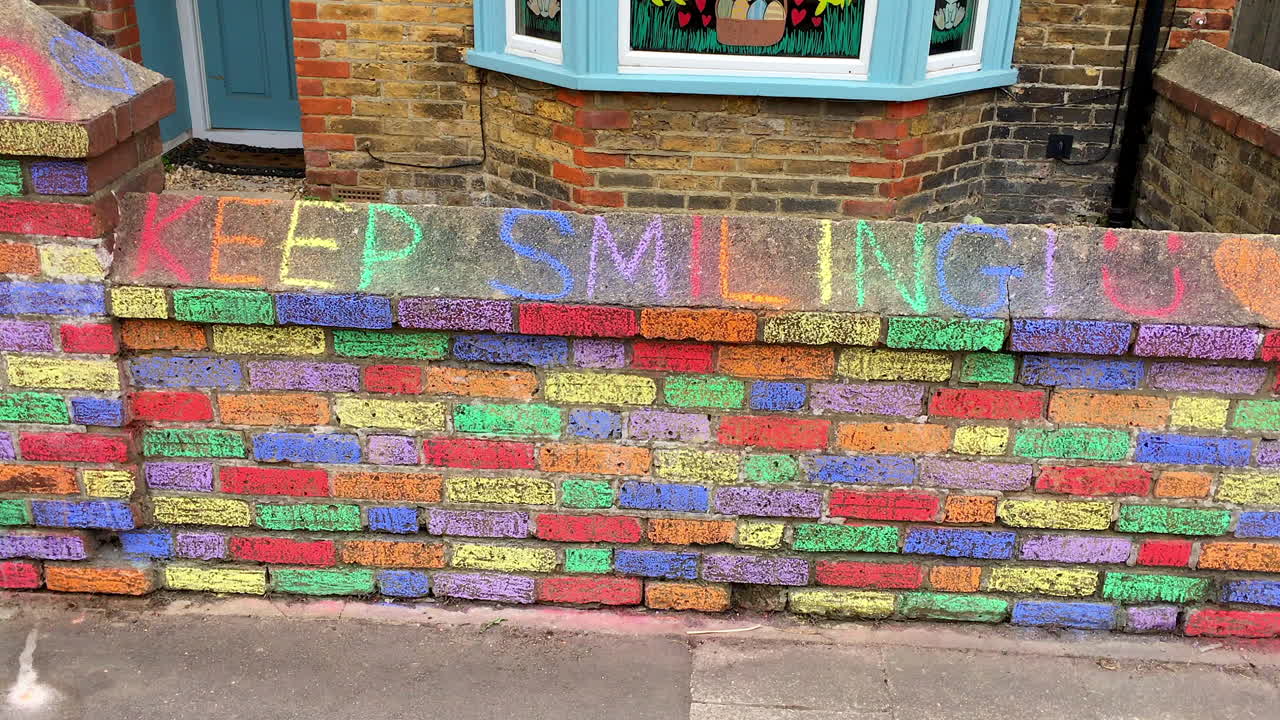 House with signs urging cheerfulness during coronavirus outbreak