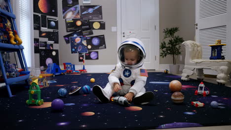 baby astronaut playing in space-themed bedroom