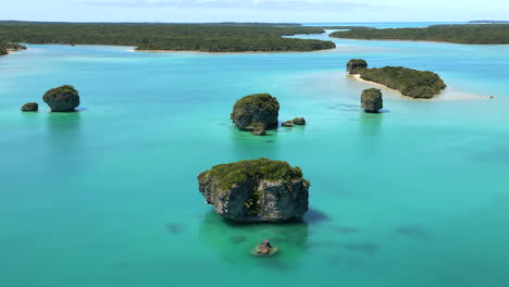 upi bay on the isle of pines is dotted with small rock islands - aerial parallax