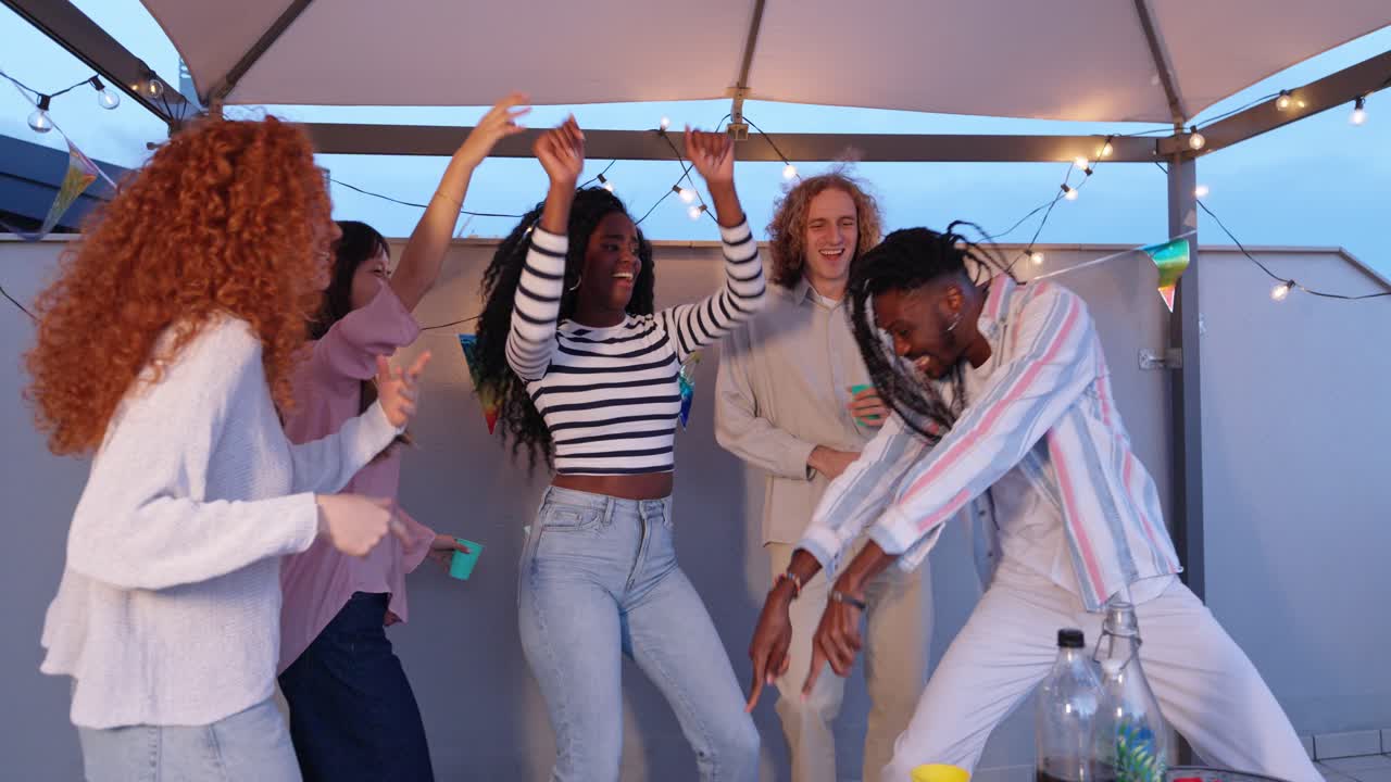 Friends dancing at rooftop party