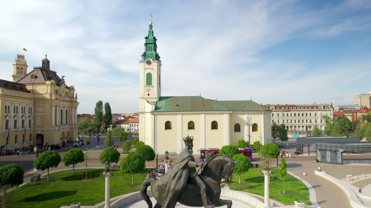 Areal drone view of the Unirii Square in Oradea downtown, Romania. King Ferdinand I statue, Saint Ladislaus Church and Town Hall, walking people
