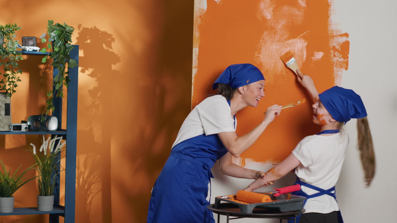 Mother and daughter painting a wall together