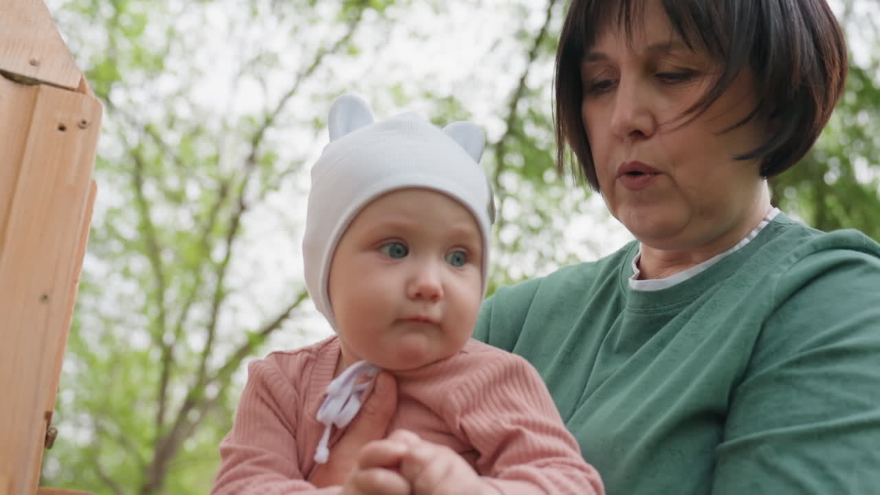 Elderly And Child Examine Textures, Child And Grandmother Interact With Natural Surface Textures Outside, Young Person And Older Woman Investigate Different Natural Surface Feelings Outdoors