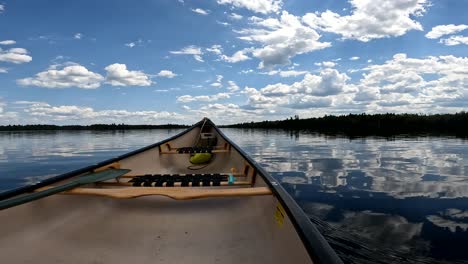 crossing calm lake in canadian canoe relaxing perspective