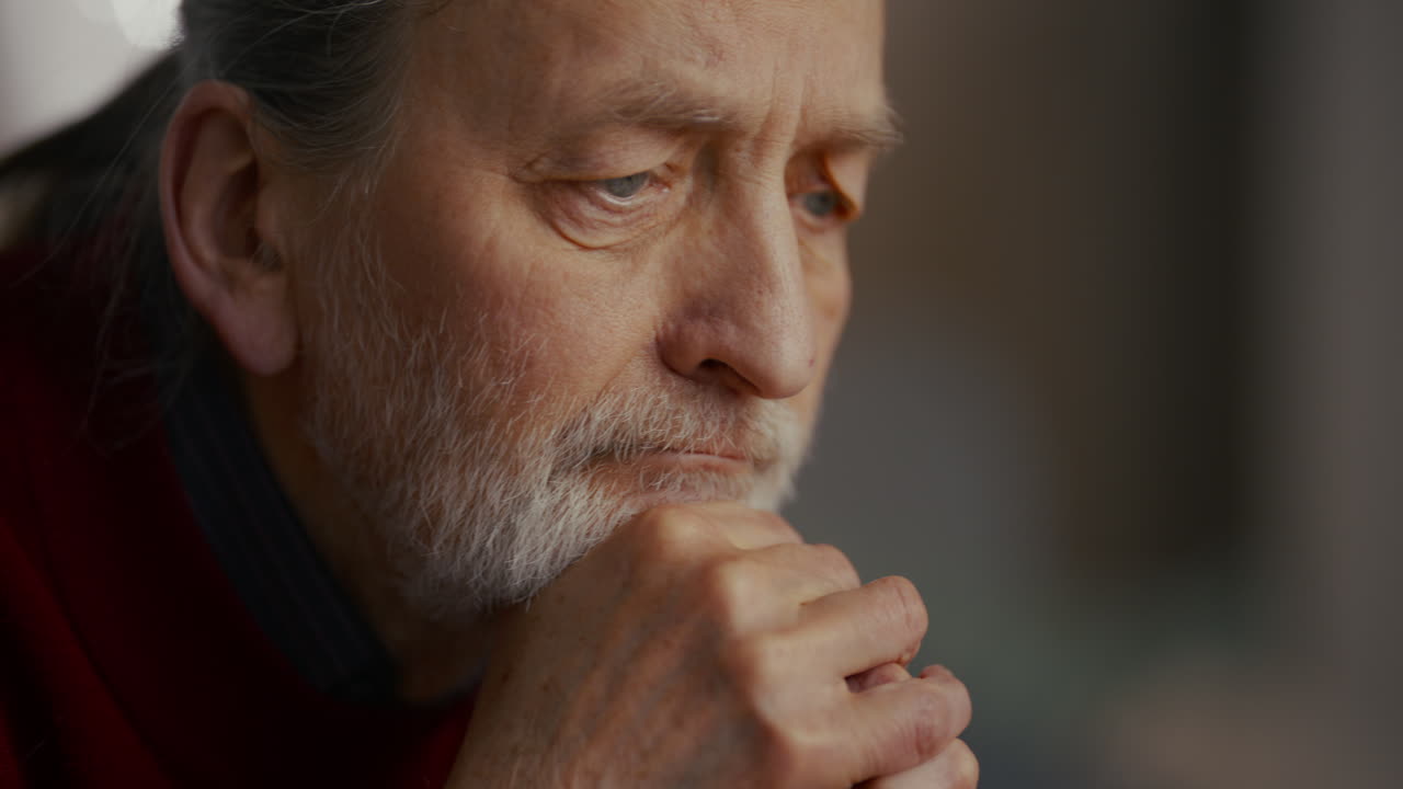 Close Up of Pensive Elderly Man with Eyes Closed