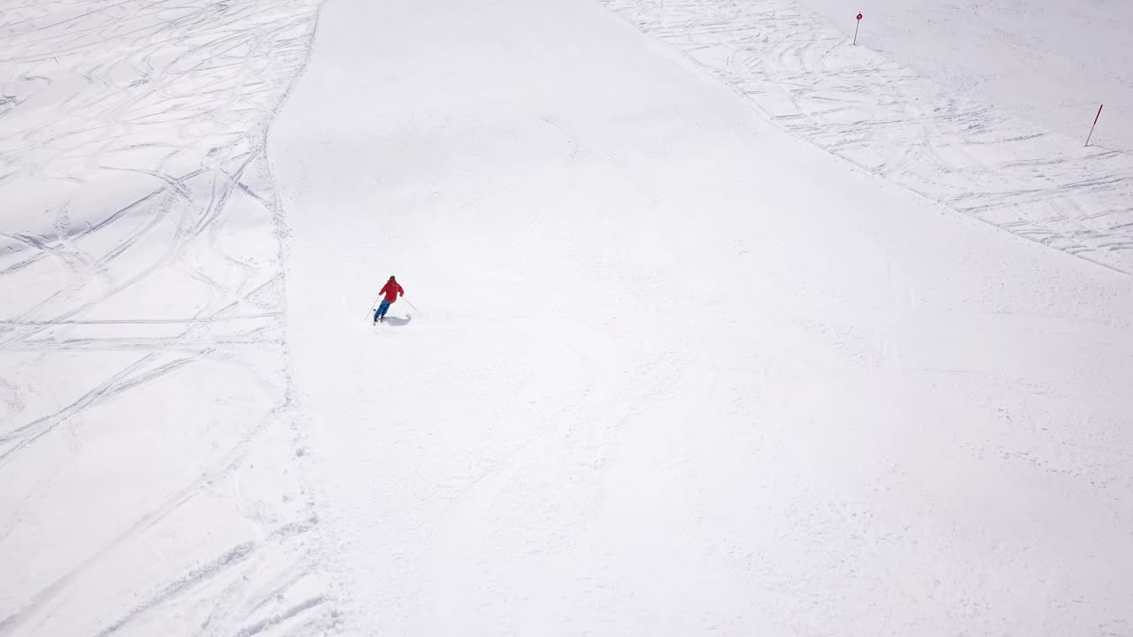 4k aerial footage, drone following skiers on ski slope in skiing region