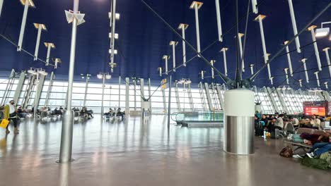 passengers moving through a modern airport terminal