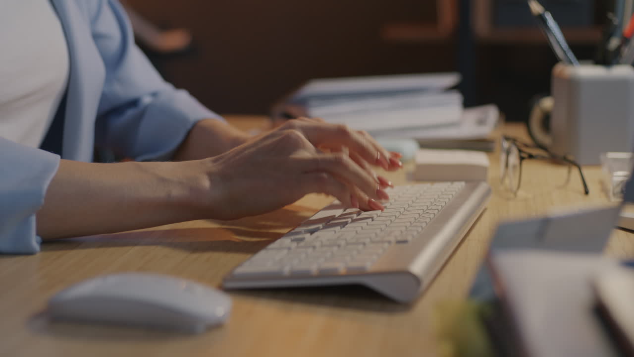 Woman typing on a keyboard at her desk