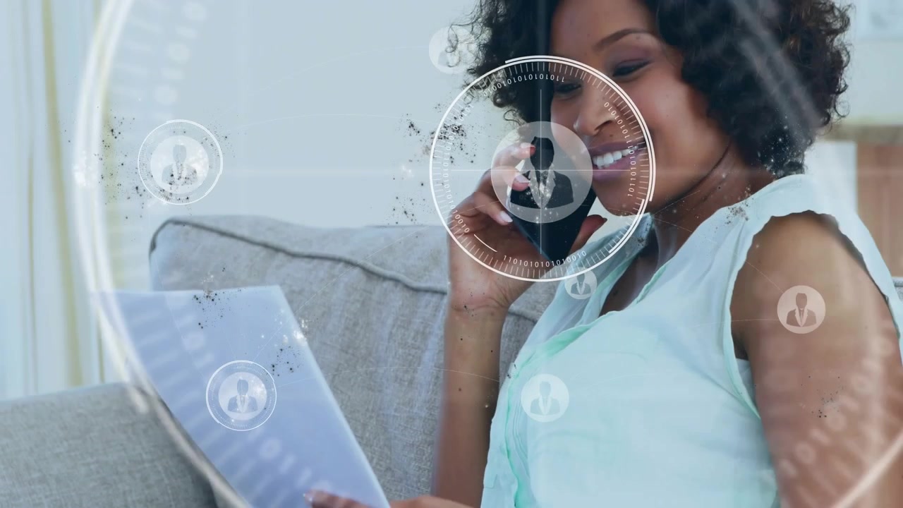 Woman sitting sofa holding phone reviewing docs business call starting HUD icons growing around her