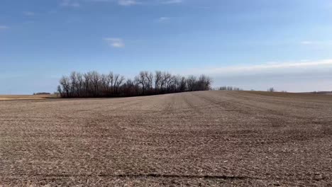 a countryside view through moving car showing barren land of southwest minnesota