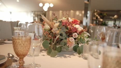 close up of a wedding table centerpiece with soft toned flowers
