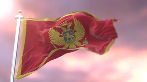 flag of montenegro waving at wind at sunset in slow, loop